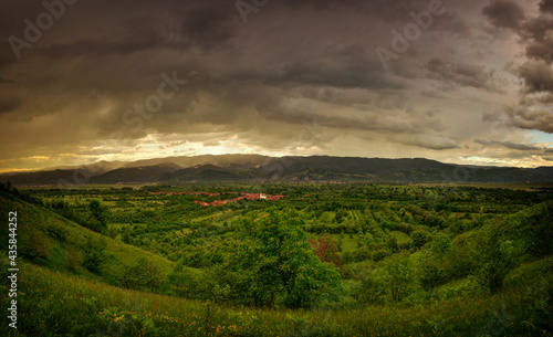 Storm scene with green hills and dark clouds