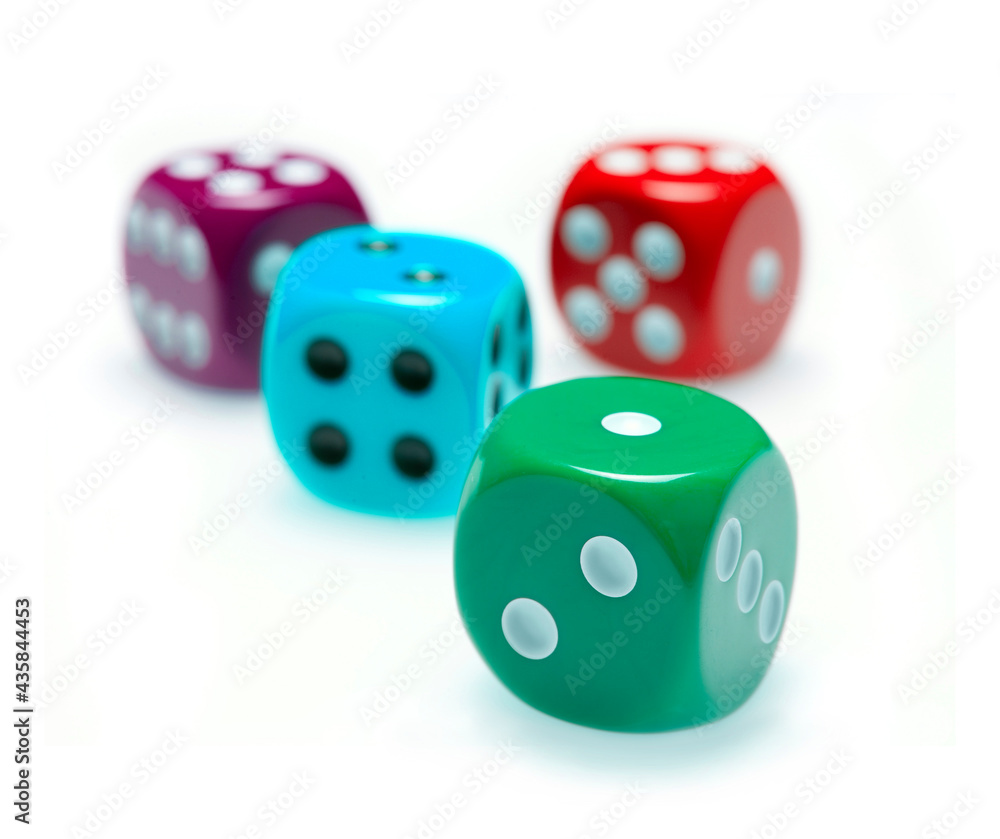 four colorful dice on white background with selective focus four colorful dice on white background with selective focus