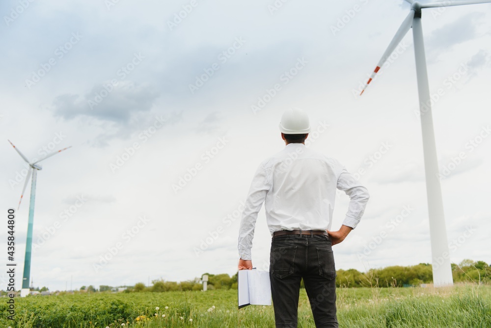 Engineer inspecting Project Manager at the Wind Farm. Man working in the enviromental Engineer inspecting Project Manager at the Wind Farm. Man working in the enviromental