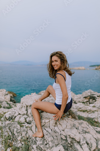 Woman sunbathing and posing at the beach at the ocean