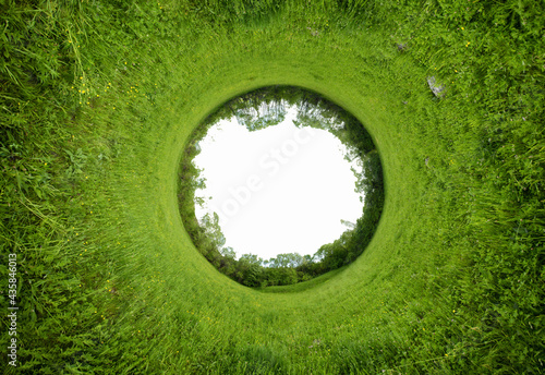 Stereographic panoramic projection of a green field in the summer. 360 degree panorama.