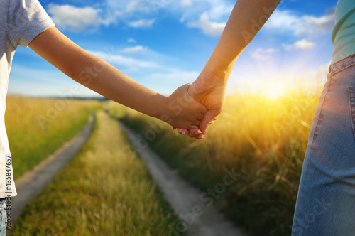 Hands of holding each other in field