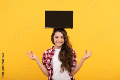 happy smart teen girl meditating with laptop on head presenting school online lesson, estudy