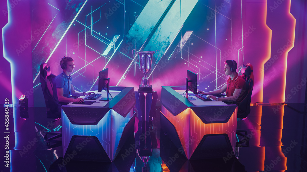 Obraz premium Two Esport Gamers Competition in a Video Game on a Championship Arena. Two Boys Playing Computer in front of Each Other. International Online Cyber Gaming Tournament Live Streaming Event
