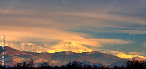 Snow covered mountain peaks in sunset. Location is Tarcu Mountains in Romania © Mihai