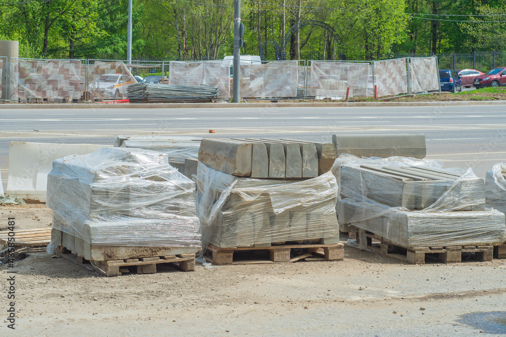 A stack of packed curbstone on the road.