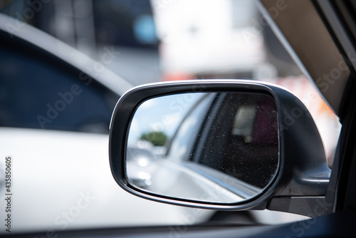 Close up of car mirror with reflection of a beautiful landscape.