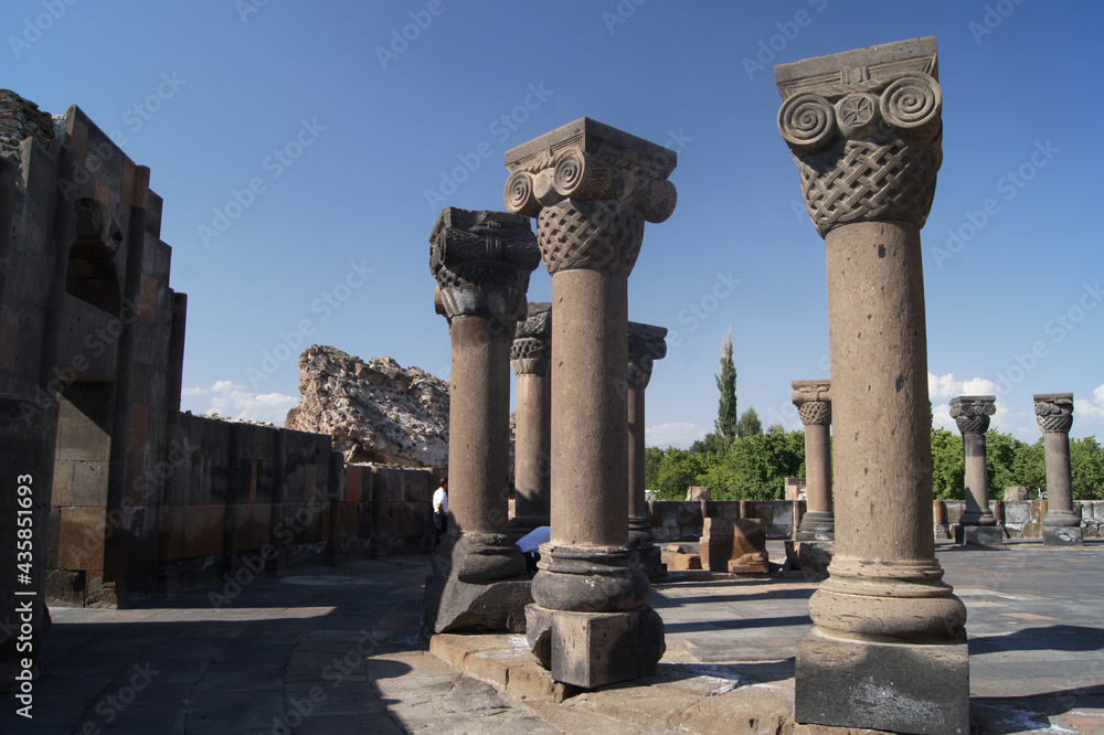 ancient stone columns against the background of the old monastery