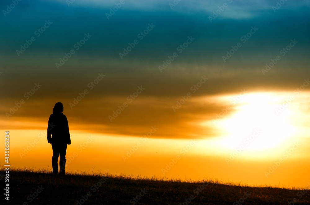 Silhouette of girl in sunset.