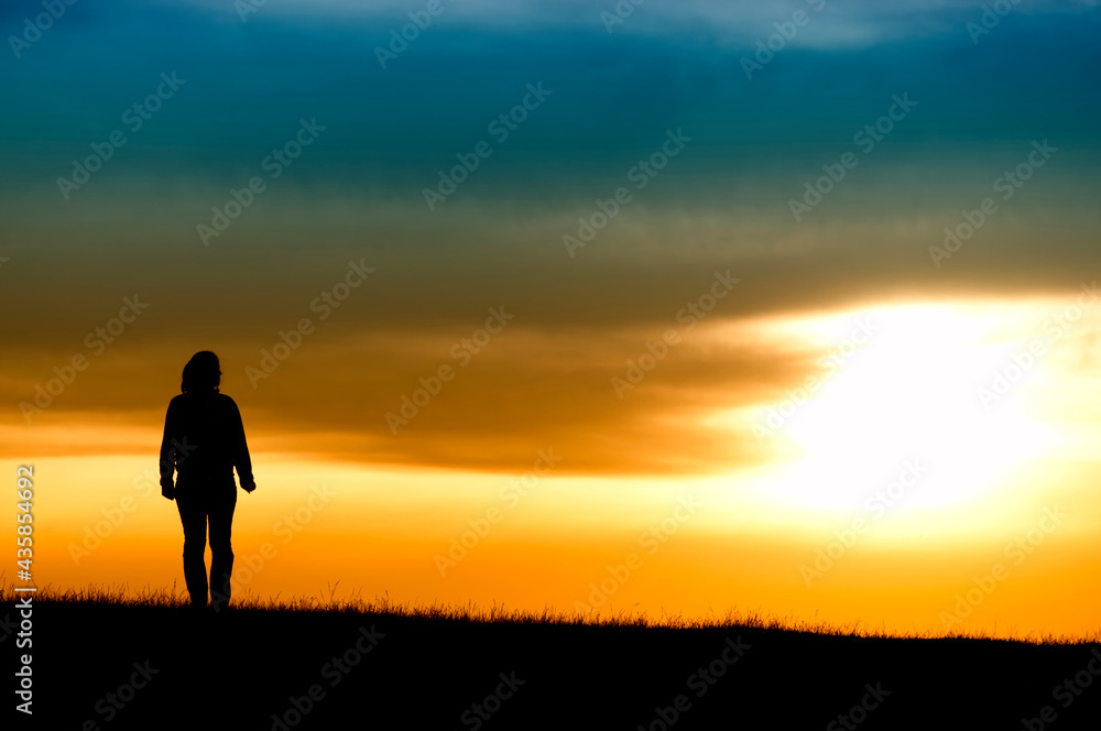 Silhouette of girl in sunset.