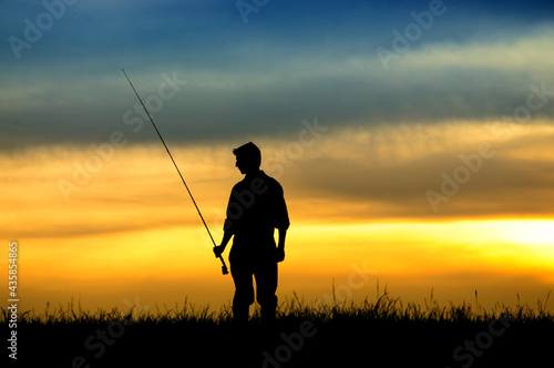 Silhouette of fisherman in sunset.