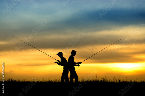 Silhouette of fishermen in sunset.
