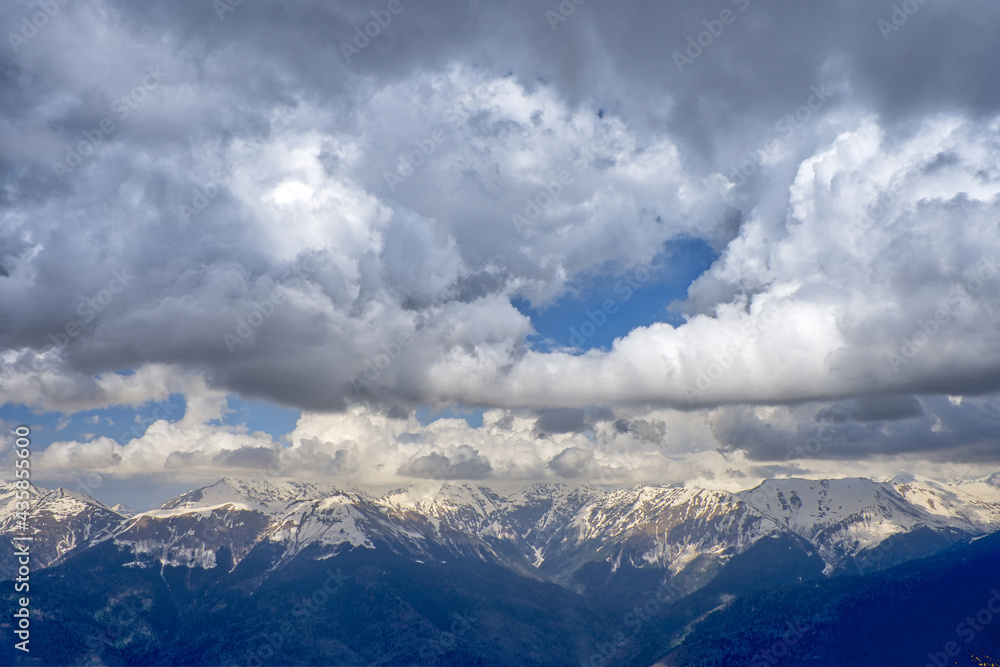 Mountain snow-capped peaks in the clouds. Tourist routes. Extreme tourism, extreme sports. Climbing the peaks. Mountain snow-capped peaks in the clouds. Tourist routes. Extreme tourism, extreme sports. Climbing the peaks.