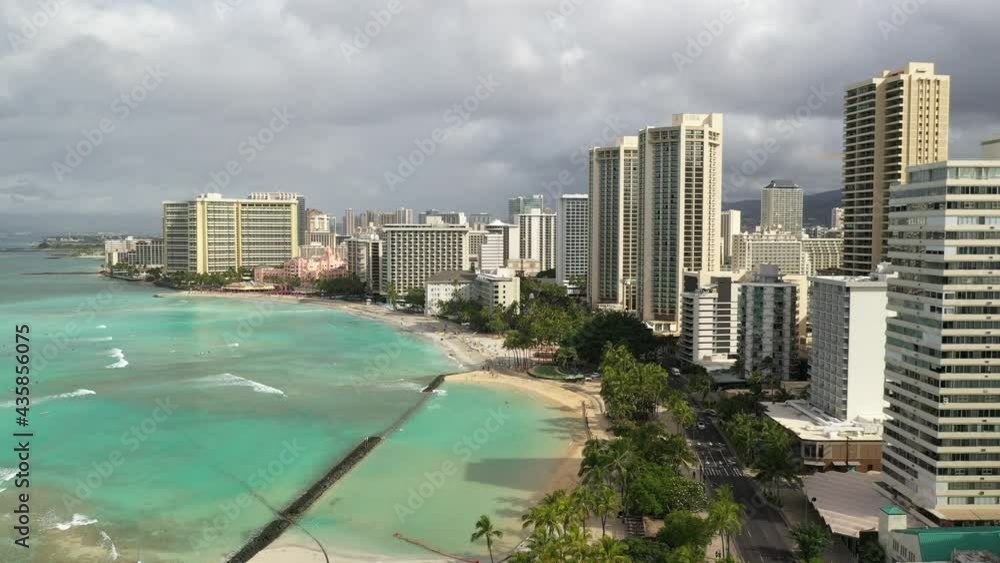 Cinematic 4K drone dolly flyover shot of high-rise hotels on the shore of Waikiki, vibrant, popular tourist destination near Honolulu on Oahu island in Hawaii known for its popular surf beach Cinematic 4K drone dolly flyover shot of high-rise hotels on the shore of Waikiki, vibrant, popular tourist destination near Honolulu on Oahu island in Hawaii known for its popular surf beach