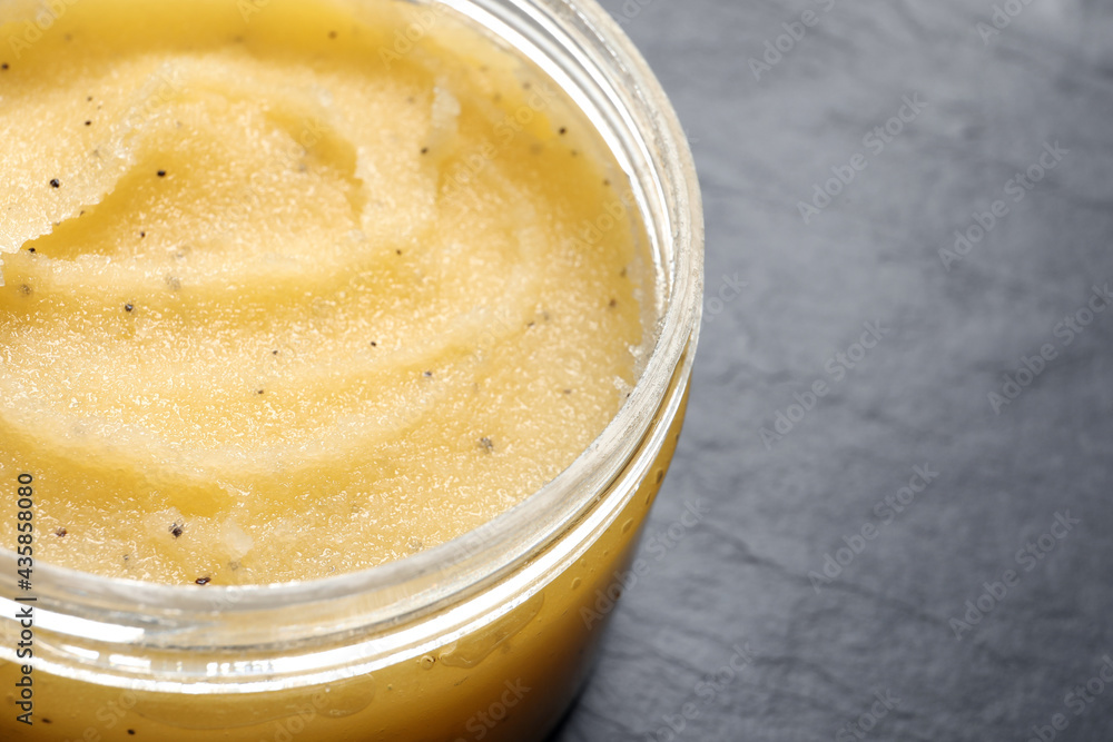 Body scrub in jar on dark table, closeup. Space for text Body scrub in jar on dark table, closeup. Space for text