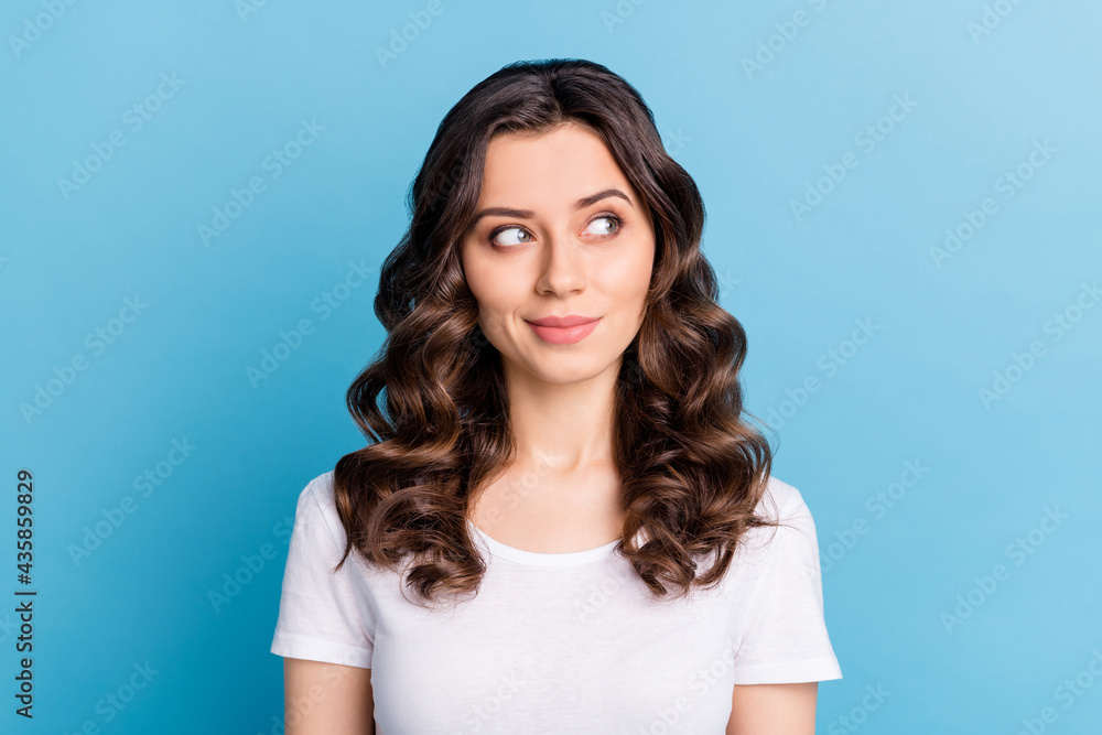 Photo of charming cute young woman wear white t-shirt smiling looking empty space isolated blue color background Photo of charming cute young woman wear white t-shirt smiling looking empty space isolated blue color background