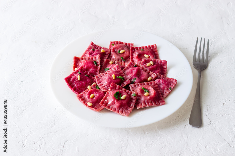 Beet ravioli with ricotta cheese, spinach and nuts. Healthy eating. Vegetarian food. Italian cuisine. Beet ravioli with ricotta cheese, spinach and nuts. Healthy eating. Vegetarian food. Italian cuisine.