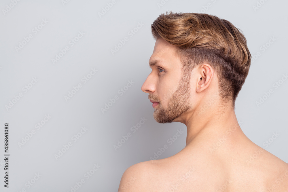 Profile photo of young blond man look empty space without clothes isolated on grey color background Profile photo of young blond man look empty space without clothes isolated on grey color background