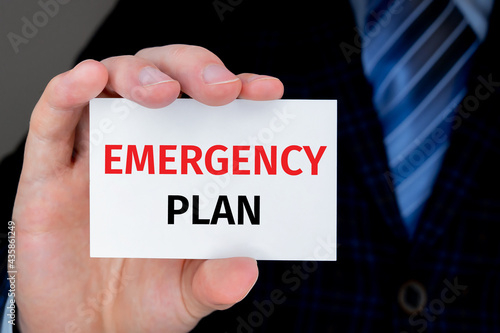 EMERGENCY PLAN text on a card help by businessman. PLANB concept. photo