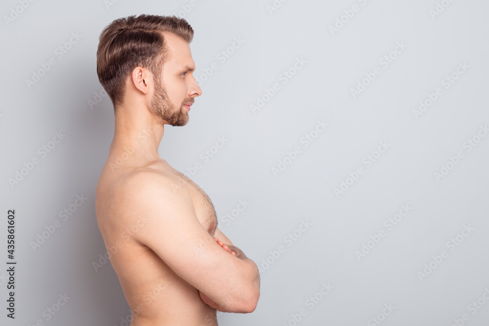 Fototapeta premium Profile side view portrait of attractive fit sportive man folded arms copy blank space ad isolated over grey pastel color background