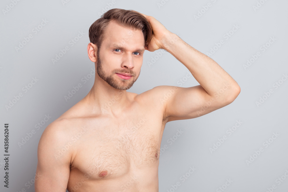 Photo of serious blond hairdo guy touch hair without clothes isolated on grey color background Photo of serious blond hairdo guy touch hair without clothes isolated on grey color background