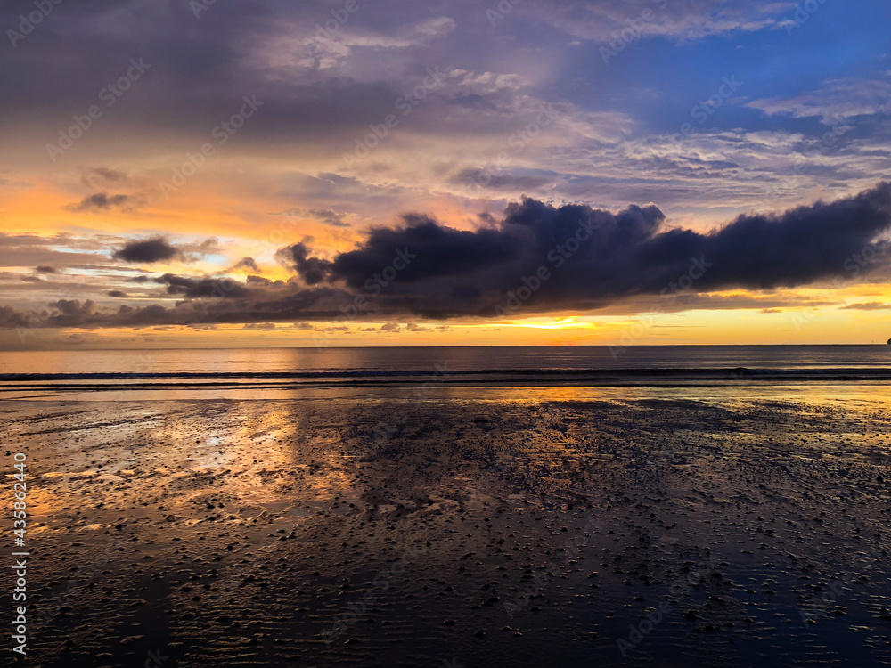 golden colourful mirror sunset at beach with reflection at kota kinabalu malaysia