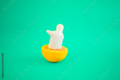 The white figure of a man on an orange shows his hand and a blue-green background. Pastel colors and space for text. Summer parties are coming.
