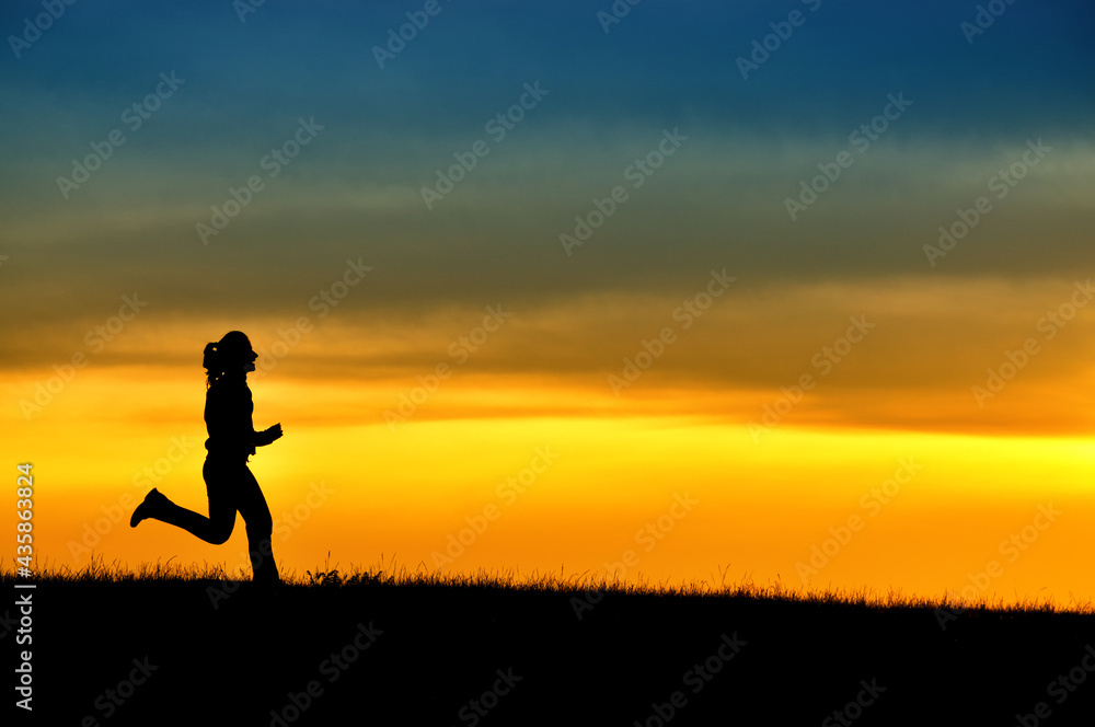 Silhouette of girl running in sunset