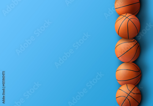 Many orange basketball balls on blue background. Space for text © New Africa