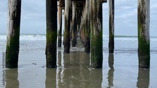 Waves rolling in under the pier at the Cayucos State Beach, California 