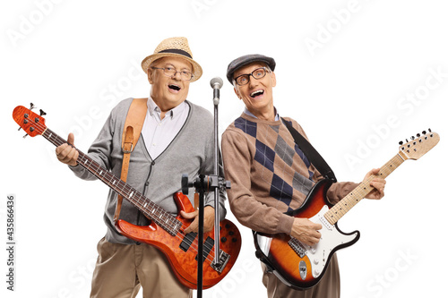 Seniors playing guitars and singing on a microphone © Ljupco Smokovski