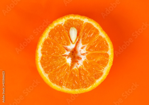 Piece of orange on a red background