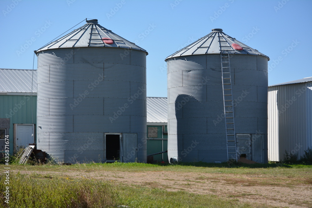 grain elevator silos in the farm field grain elevator silos in the farm field