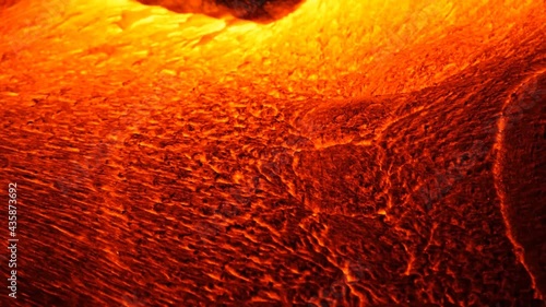 A river of incandescent lava pours out. Tons of hot magma spills