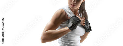 Croped shot of fitness confident female bodybuilder with power hands in gloves isolated on white. Copy space.