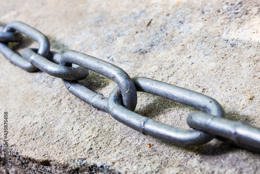 iron chain lies on a stone. Concept of Freedom. Close up macro iron chain lies on a stone. Concept of Freedom. Close up macro