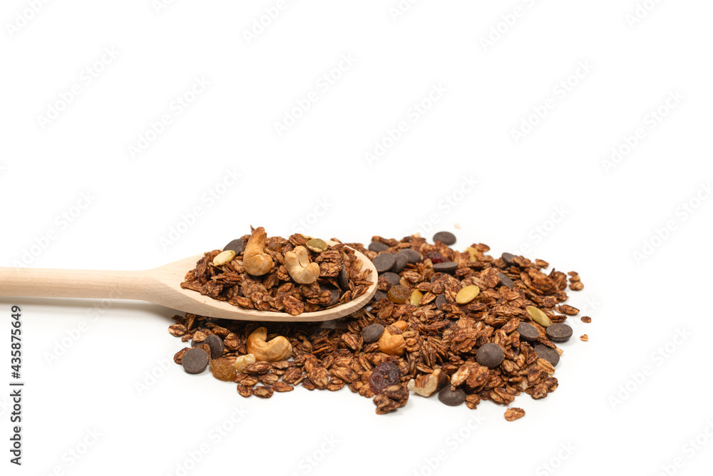 Chocolate granola cereal with nuts in a wooden spoon. Chocolate granola cereal with nuts in a wooden spoon.