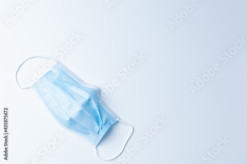 Single top view medical masks isolated on a white background. Protect coronavirus people around the world wearing mask, social distance, cleaning hand gel alcohol.