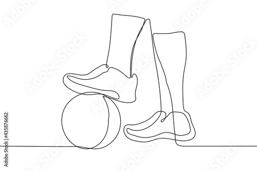 feet in boots, one of which stands on a soccer ball - one line drawing. free kick concept in football game, penalty kick