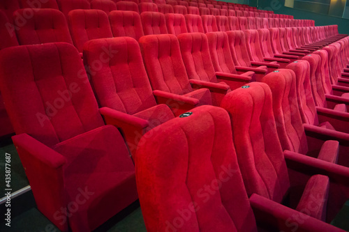 Aisle with rows of red seats