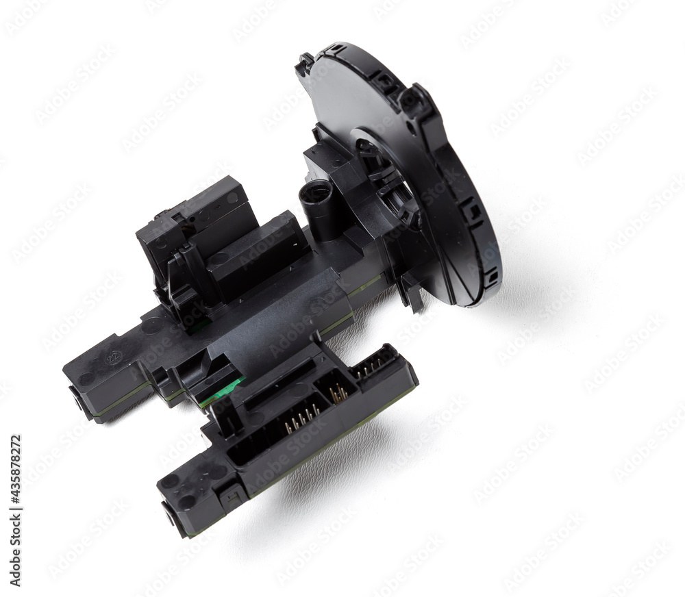 steering angle sensor disassembled on a white isolated background, spare part for car repair or for sale at junk yard. steering angle sensor disassembled on a white isolated background, spare part for car repair or for sale at junk yard.