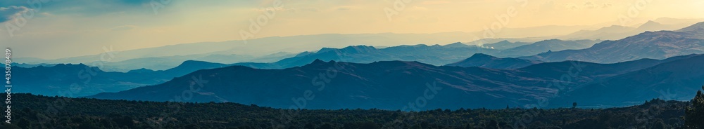 Super wide abstract panorama of hazy mountain hills, natural background, mountain silhouettes