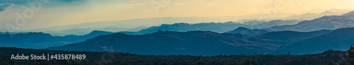 Super wide abstract panorama of hazy mountain hills, natural background, mountain silhouettes © VanSky