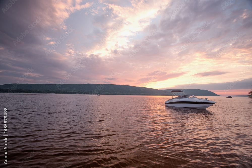 sunset over the sea. boat on the river. summer holiday and vacation concept sunset over the sea. boat on the river. summer holiday and vacation concept