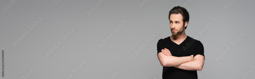 bearded man in black t-shirt posing with crossed arms isolated on grey, banner.