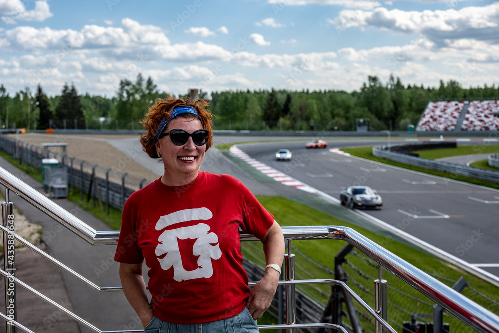 woman cheerleader in a red t-shirt at the circuit at the sports sports car races woman cheerleader in a red t-shirt at the circuit at the sports sports car races