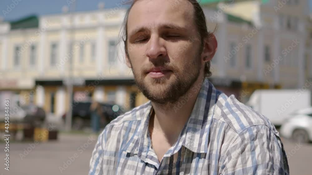 Portrait of happy smiling long haired man with a small beard looking in camera. Portrait of happy smiling long haired man with a small beard looking in camera.