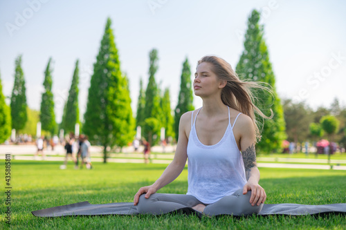 Yoga practice and meditation outdoor. Girl in the park