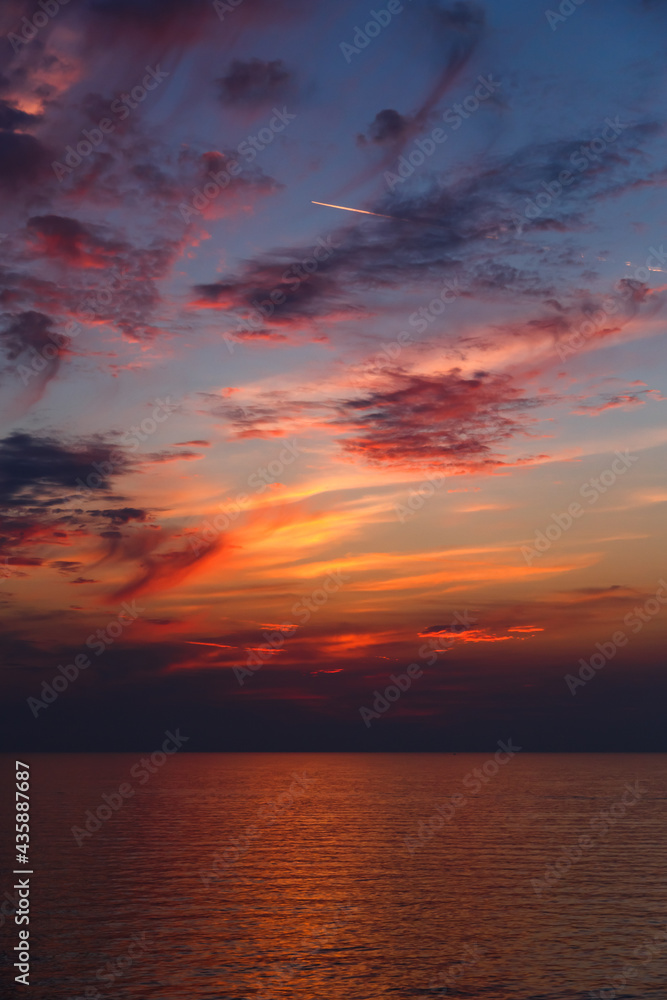 Fototapeta premium A stunning pink and orange sunset sky in the middle of Mediterranean sea, sunset background.