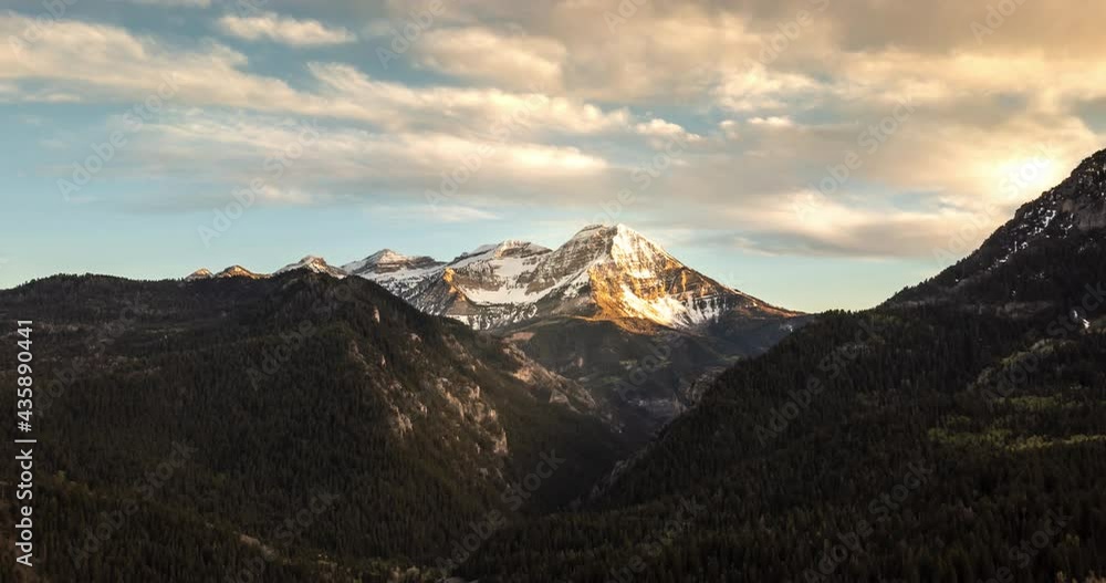Timpelapse of Clouds Over a Mountain Peak at Sunset Timpelapse of Clouds Over a Mountain Peak at Sunset